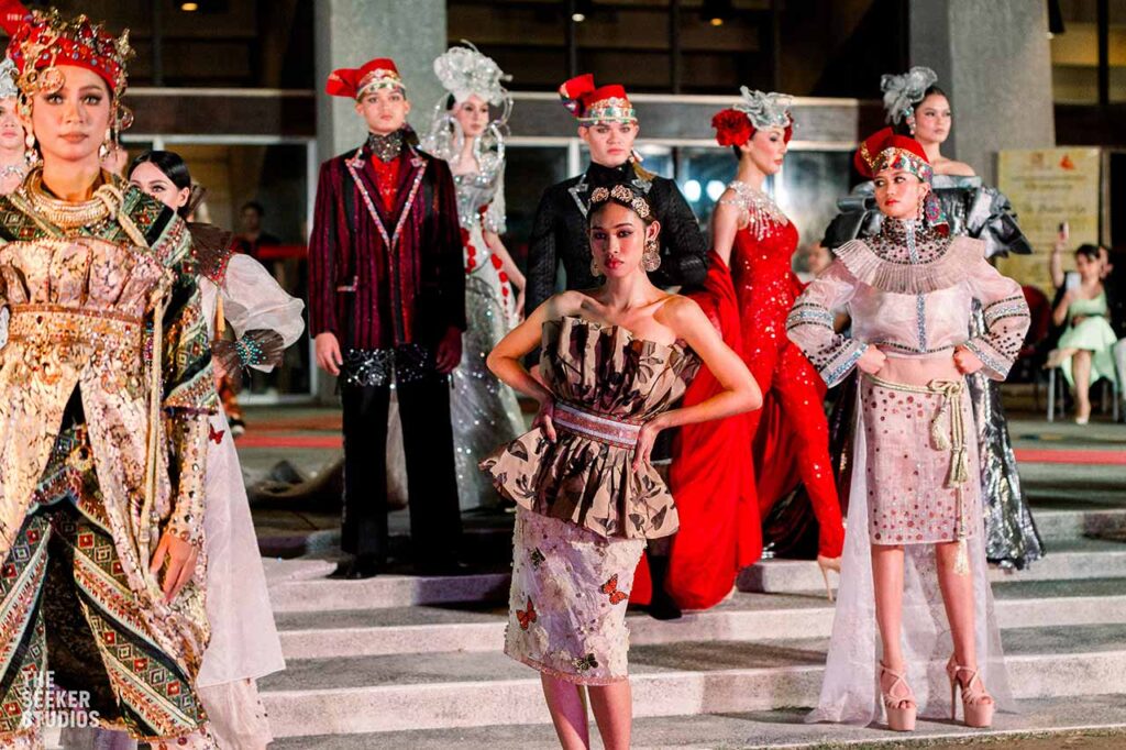 Models present the Amir Sali collection featuring elaborate garments, beadwork, embroidery, and headpieces