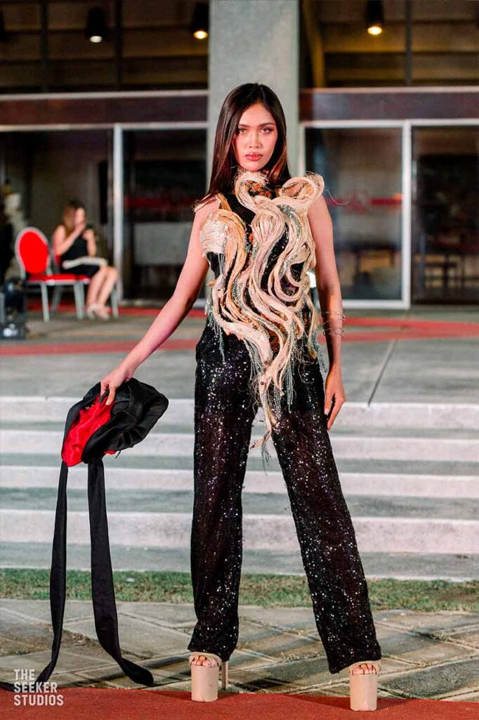 Model wearing an avant-garde Daniel Delfin design on the fashion show runway