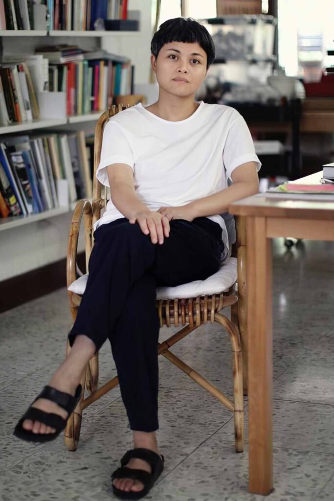Portrait of Filipina contemporary artist Maria Taniguchi seated in her studio