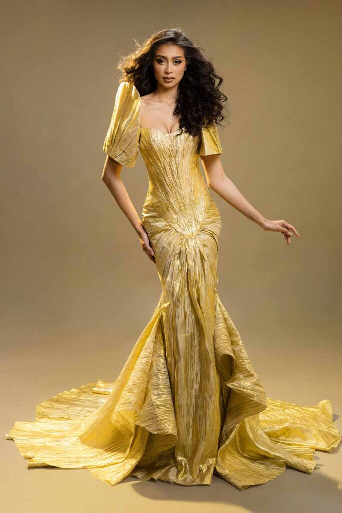 Erica Jean Cadayday, Miss Negros Oriental 2023, posing in an elegant gold Filipiniana gown with dramatic sleeves and a long flowing train