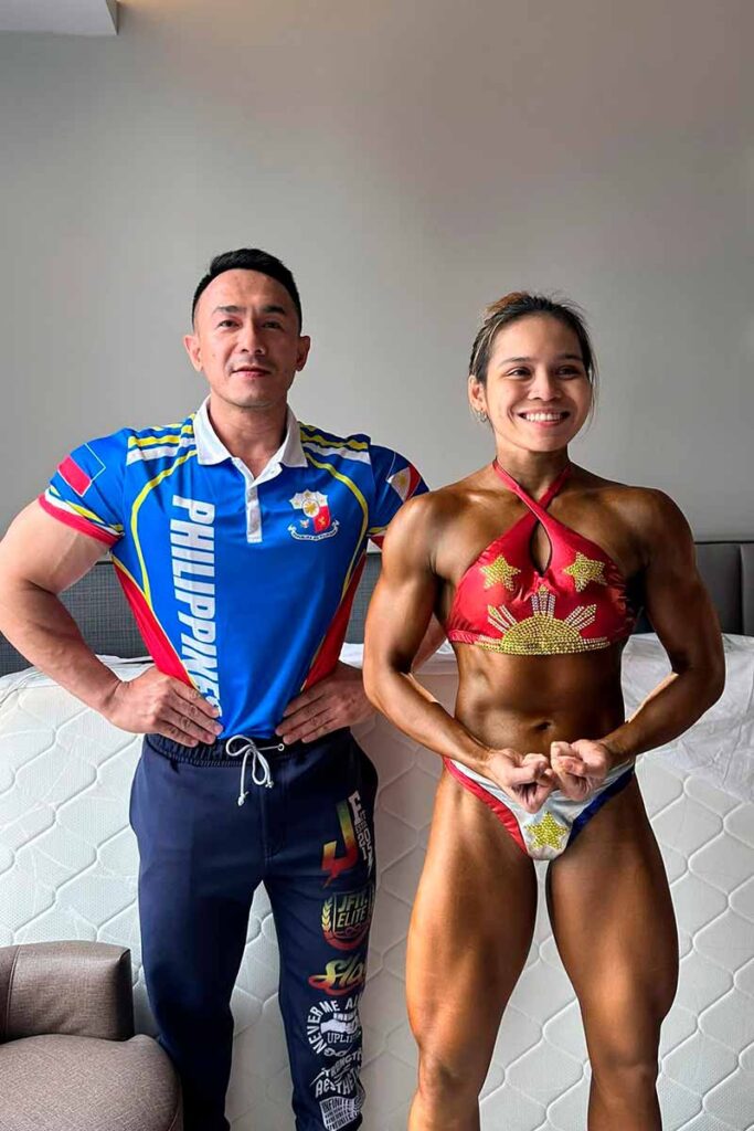 Julianna Nicole Lopez posing with her coach, Kristoff Amor, during her bodybuilding competition preparation