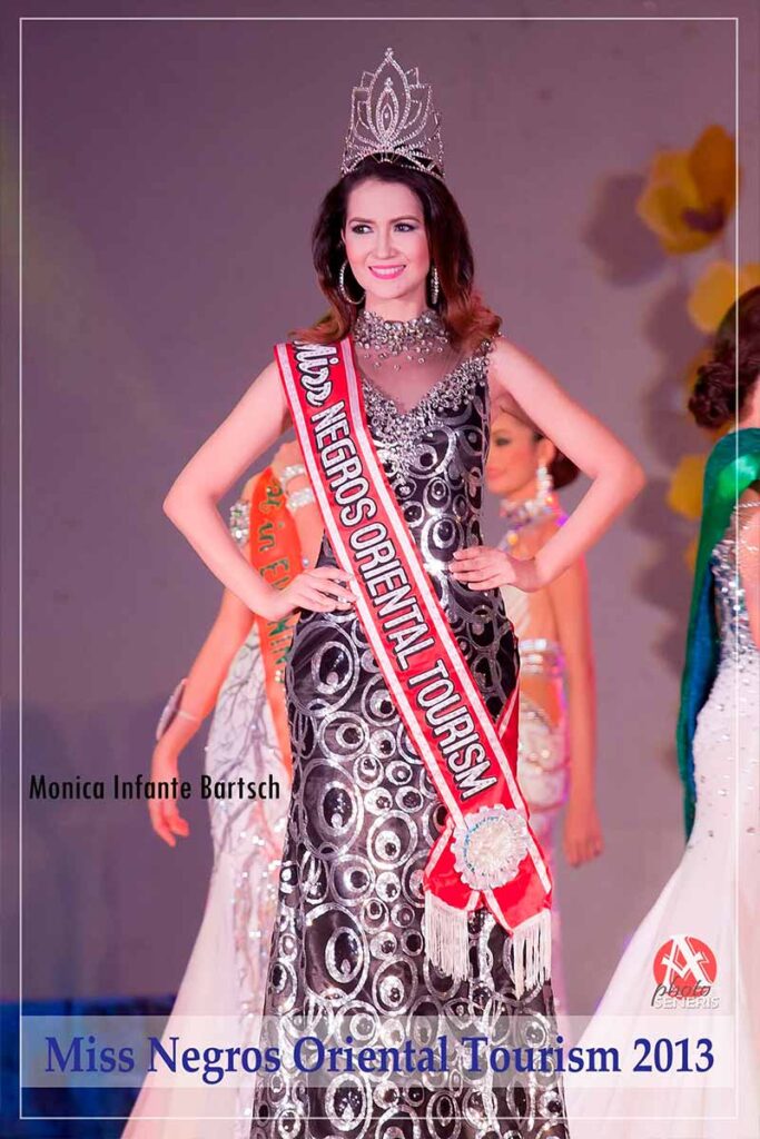 Monica Infante Bartsch wearing a crown, Miss Negros Oriental Tourism sash, and black-and-silver evening gown on stage in 2013