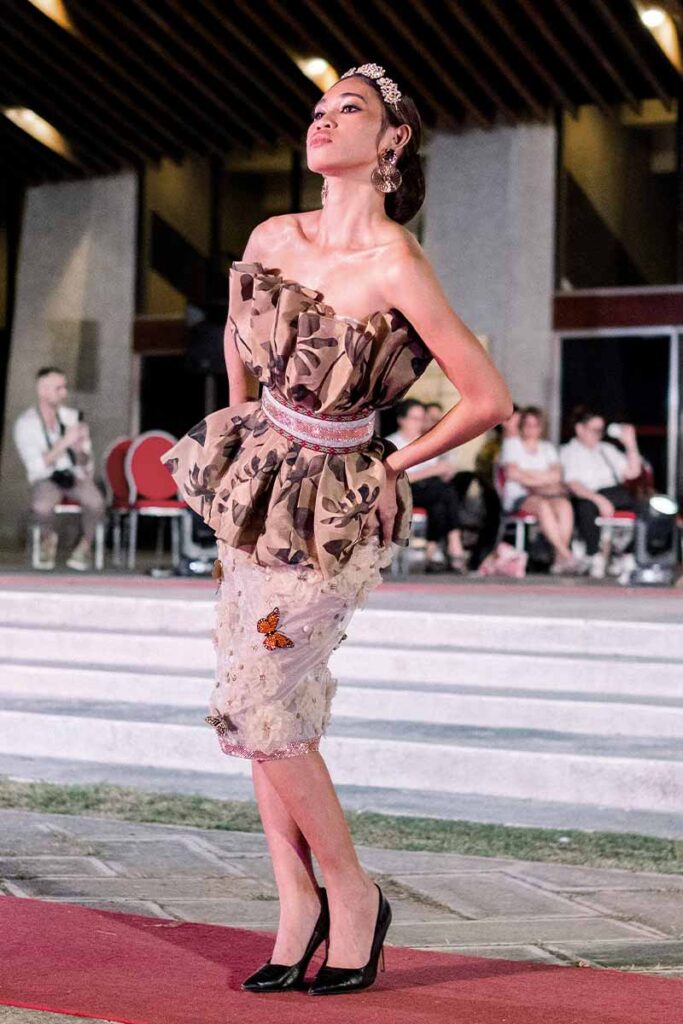 Model wearing a floral embellished runway look with butterfly details from Amir Sali’s collection