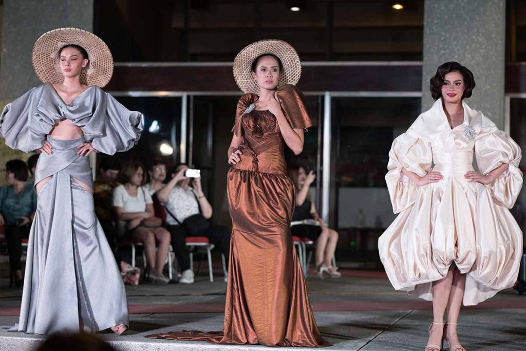 Three models wearing contemporary Filipino-inspired dresses from Josip Tumapa’s collection