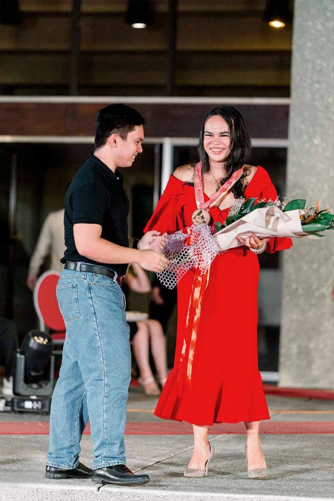 Designer Josip Tumapa receiving flowers after presenting her collection