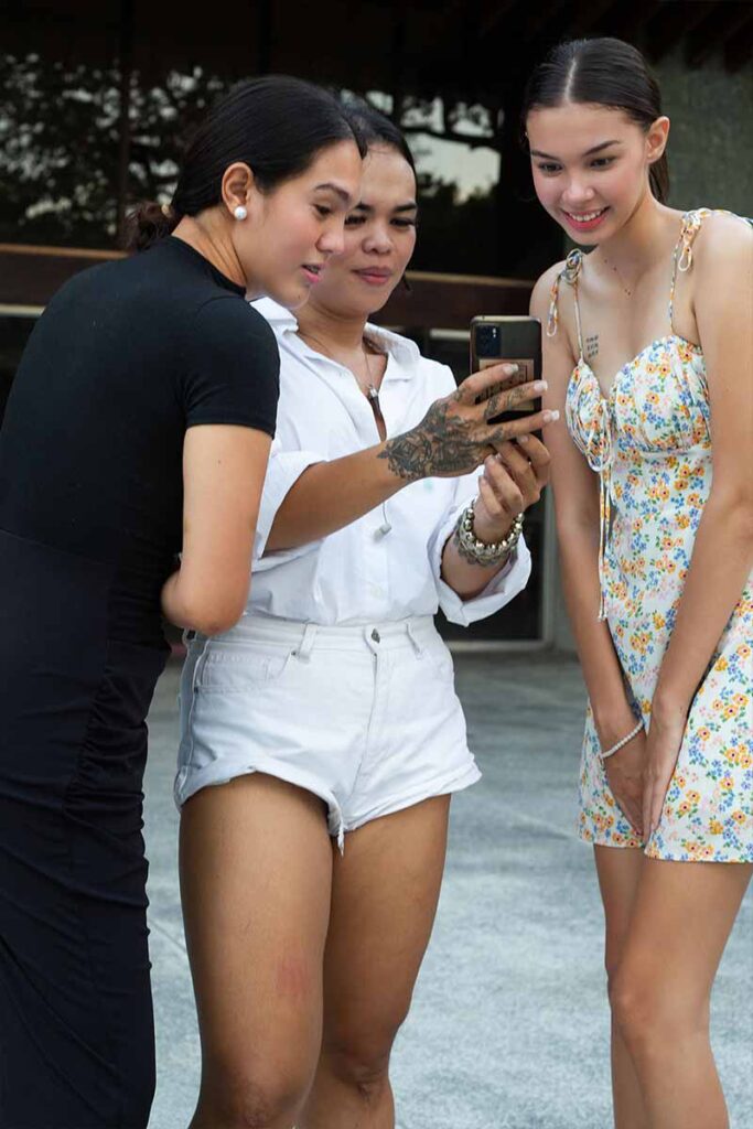 Josip Tumapa showing a photo to models during the fashion show rehearsal