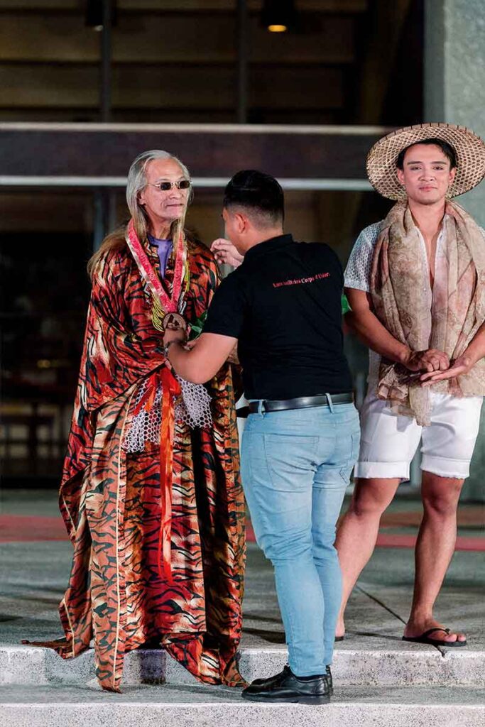 Tingting Delfin receiving flowers on the runway after the fashion show
